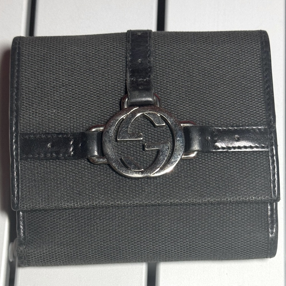 Black vintage cloth and leather Gucci bifold wallet.